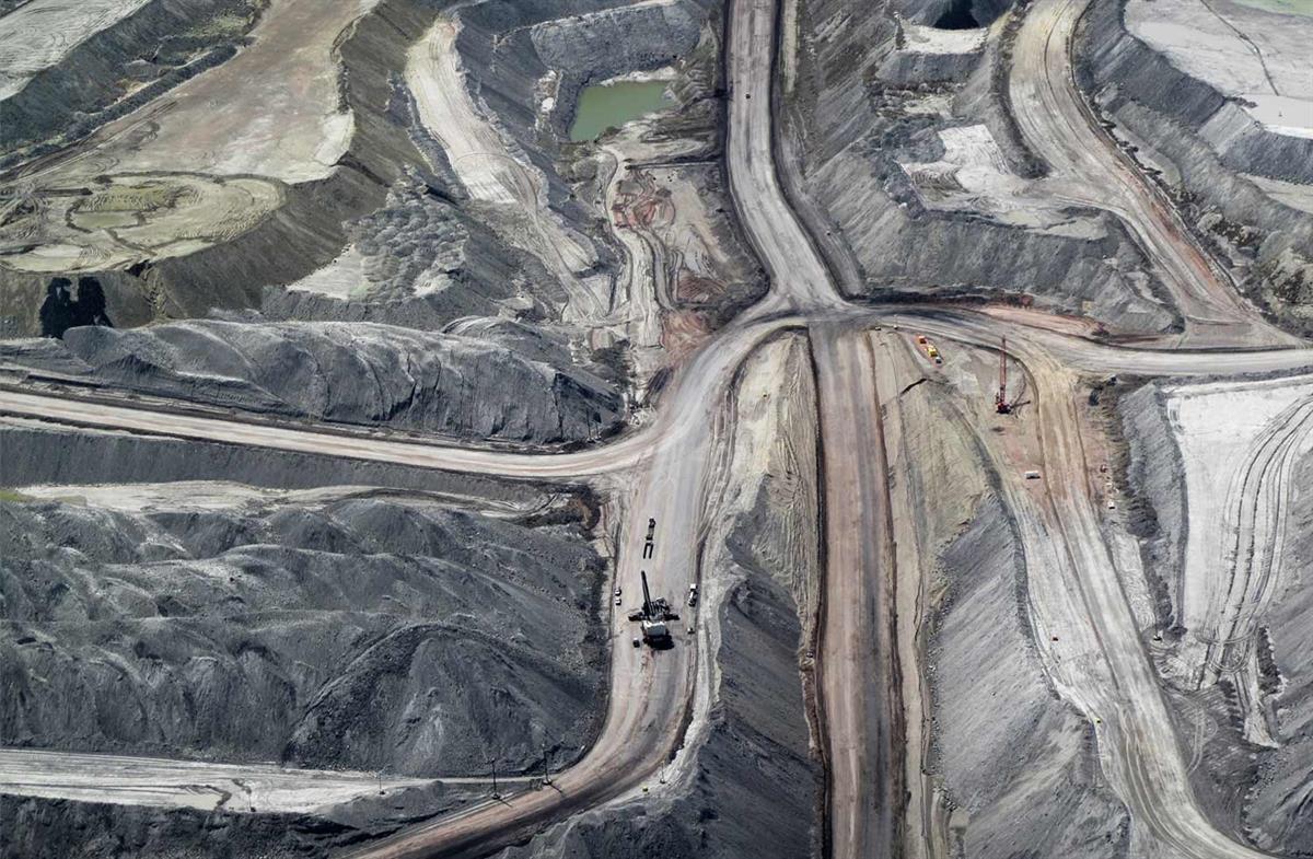 aerial view of strip mine with vehicles to show scale
