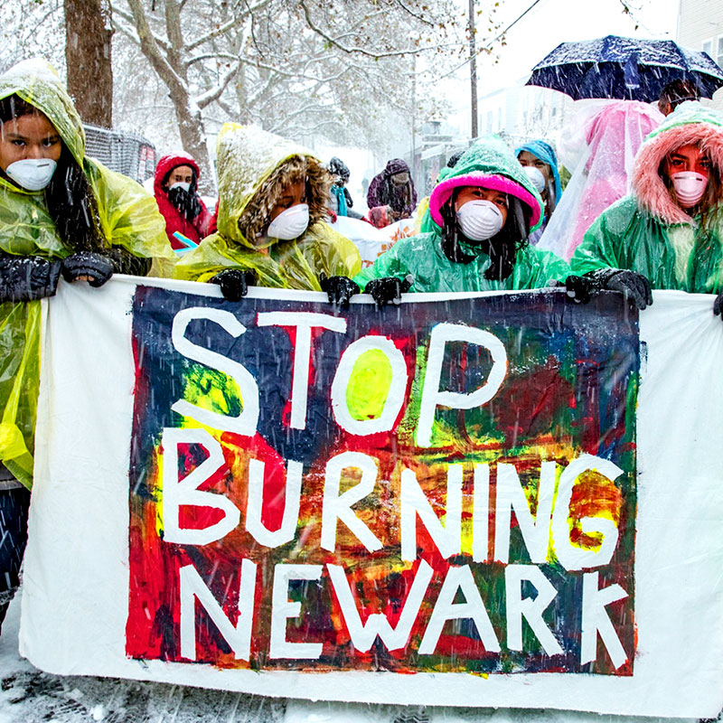 Newark citizens march in protest wearing masks during a snowstorm