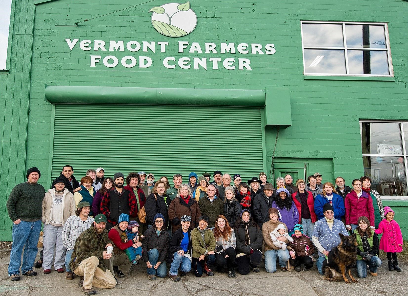 A group of people standing in front of the Vermont Farmers Food Center warehouse