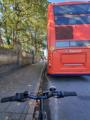A bike and a red bus on the streets of the UK