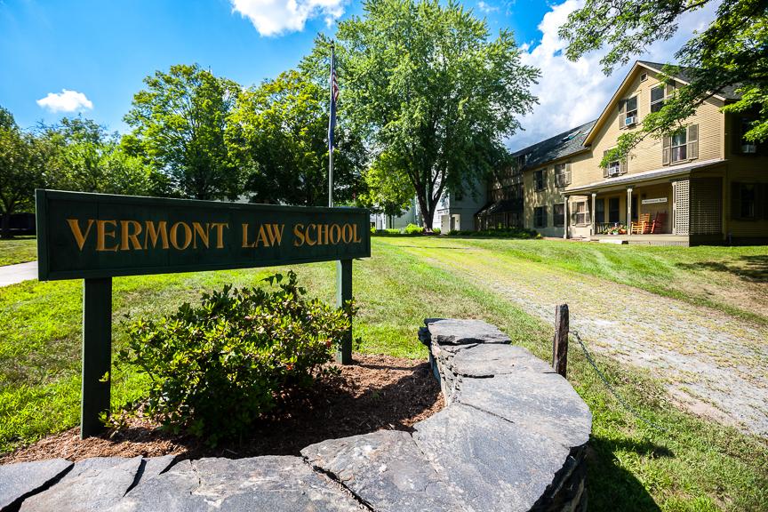 The Vermont Law School sign in front of a campus building. 