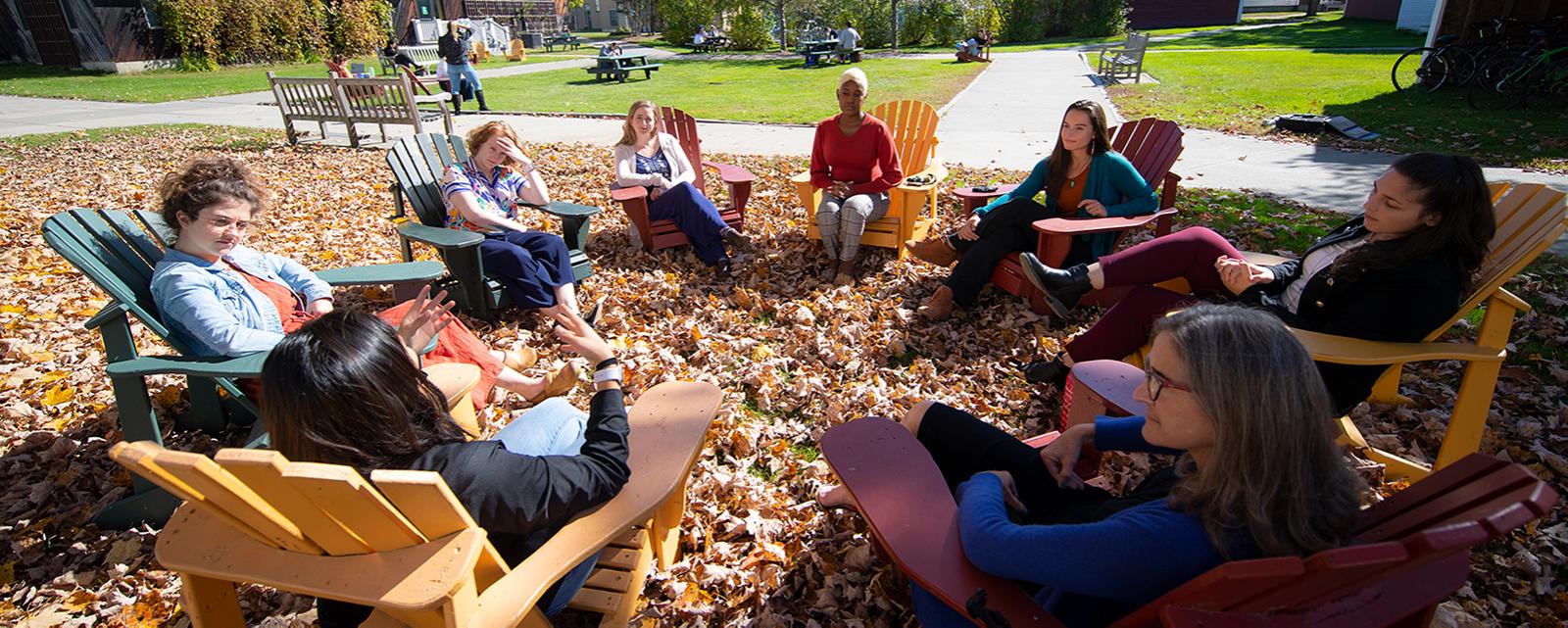 Students discussing outside in Fall Foliage