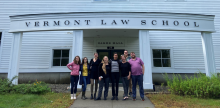 A group of six people standing in front of Oakes Hall at Vermont Law and Graduate School