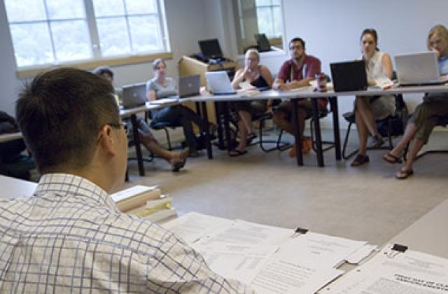 Professor Tseming Yang arranges his notes during a class in Oakes Hall