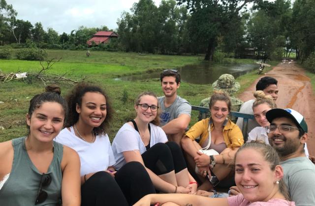 Students in the back of a truck outdoors in Southeast Asia during a field course.