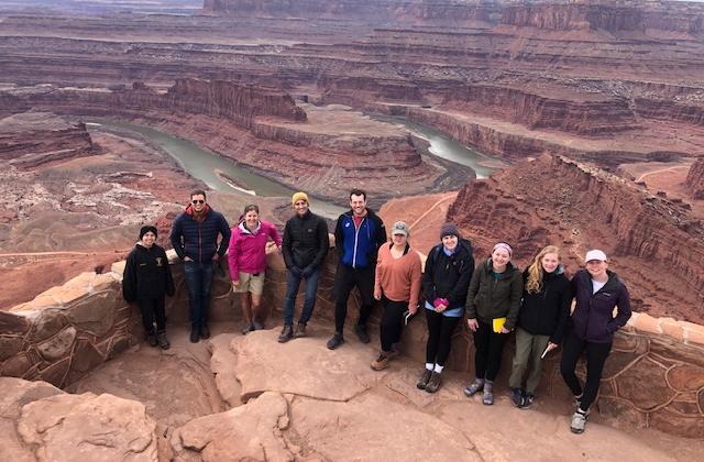Students pose for a group shot in the red desert at Canyonlands park