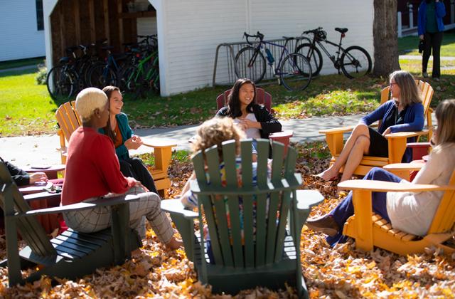 Photograph of Law Students discussing outside in the Fall Foliage.