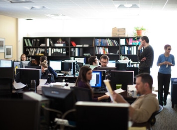 A group of people working in an office setting.