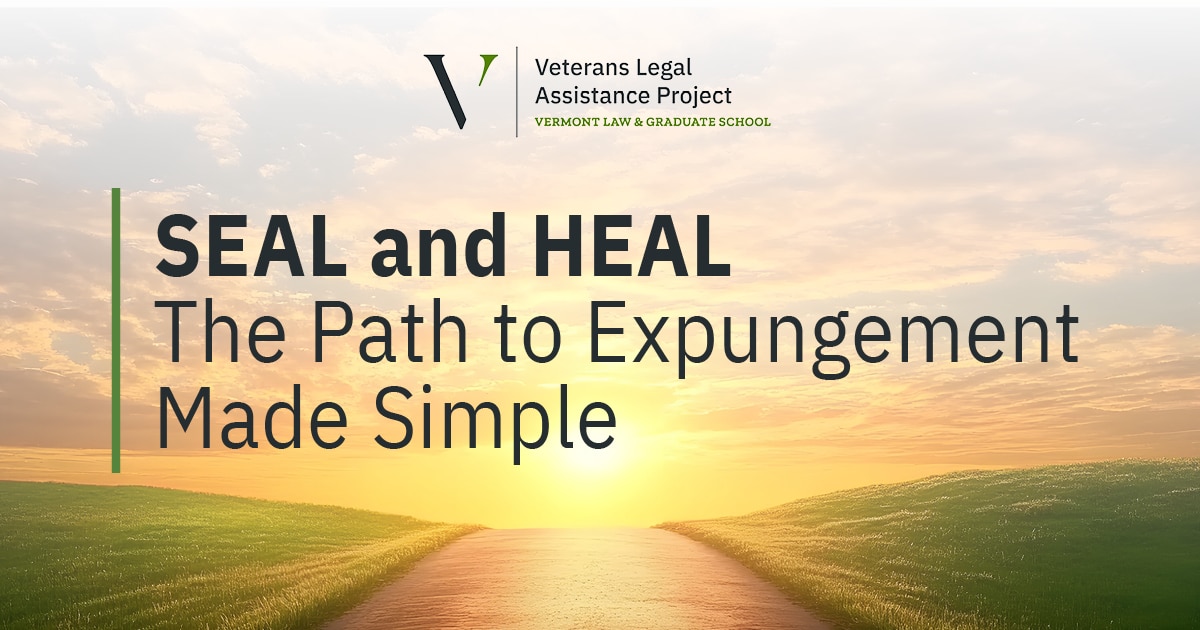 Sunset over a green, grassy hill with a road that runs though the middle