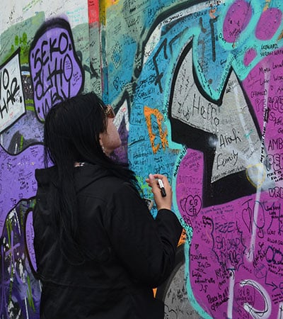 VLGS Restorative Justice students view Belfast’s murals and peace walls, signing as visitors.