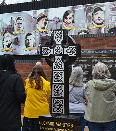 VLGS Restorative Justice students view Belfast’s murals and peace walls, signing as visitors.