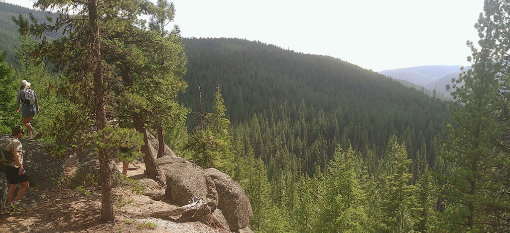 Two student hikers on a cliffside