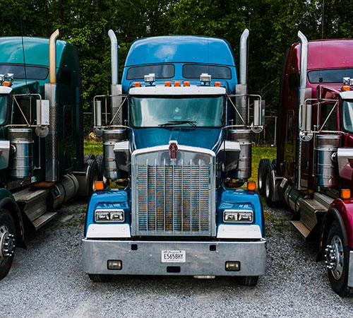 Three commercial trucks in a row.