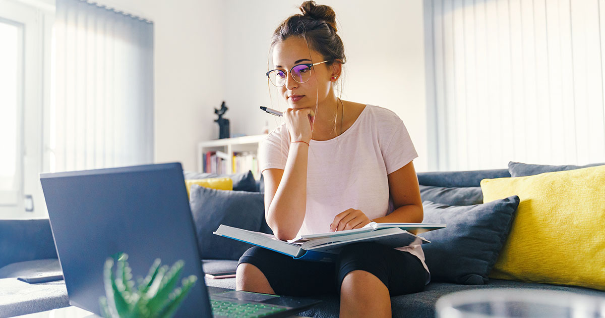 A young woman studies on a laptop