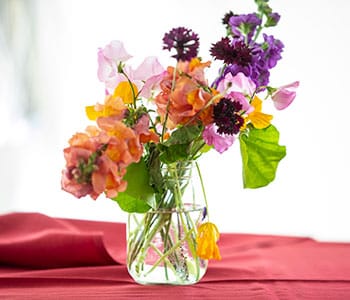 Bouquet of colorful flowers on a red tablecloth