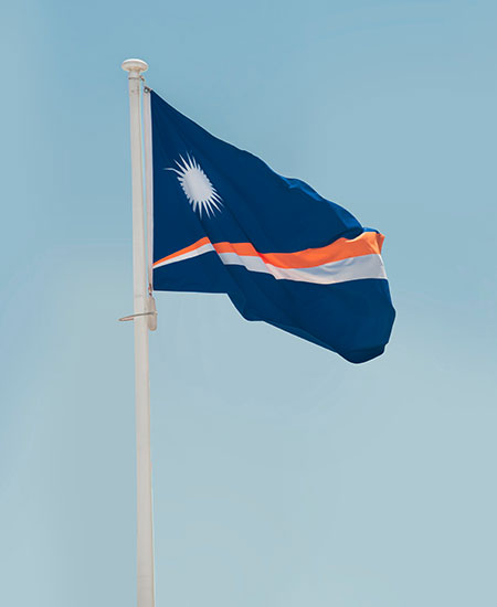 Flag of the Marshall Islands against a blue sky